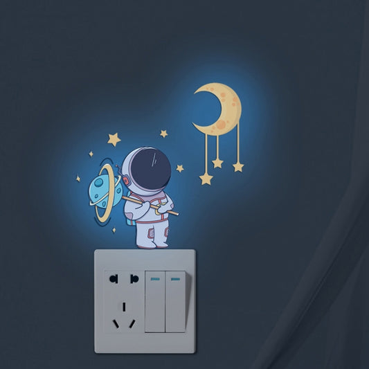 Glow astronaut and crescent moon wall sticker set on a light switch cover