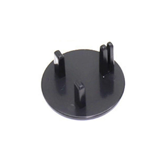 Round black UK socket protection cover with three prongs, hinged design