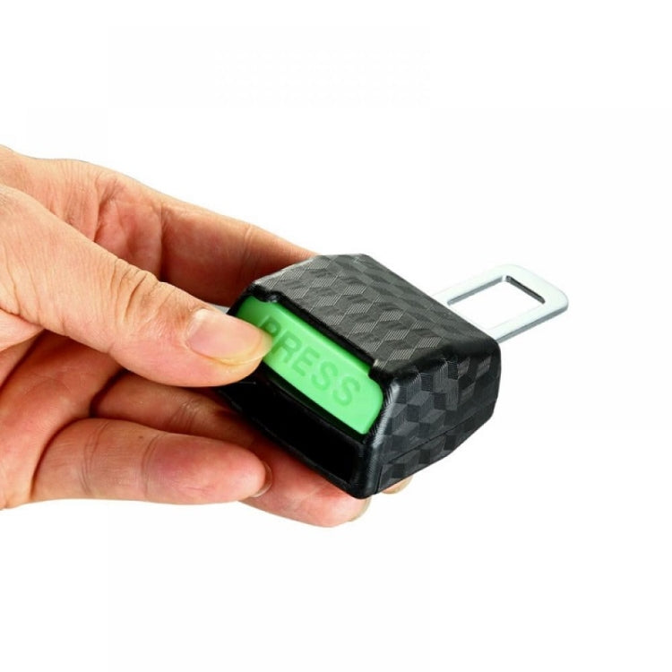 Car seat belt insert head limiter, black textured with green PRESS button, shown in hand
