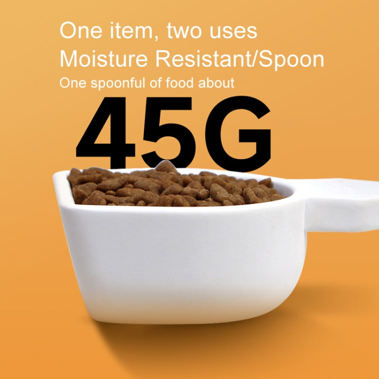 White drying scoop filled with brown granules in a white storage container