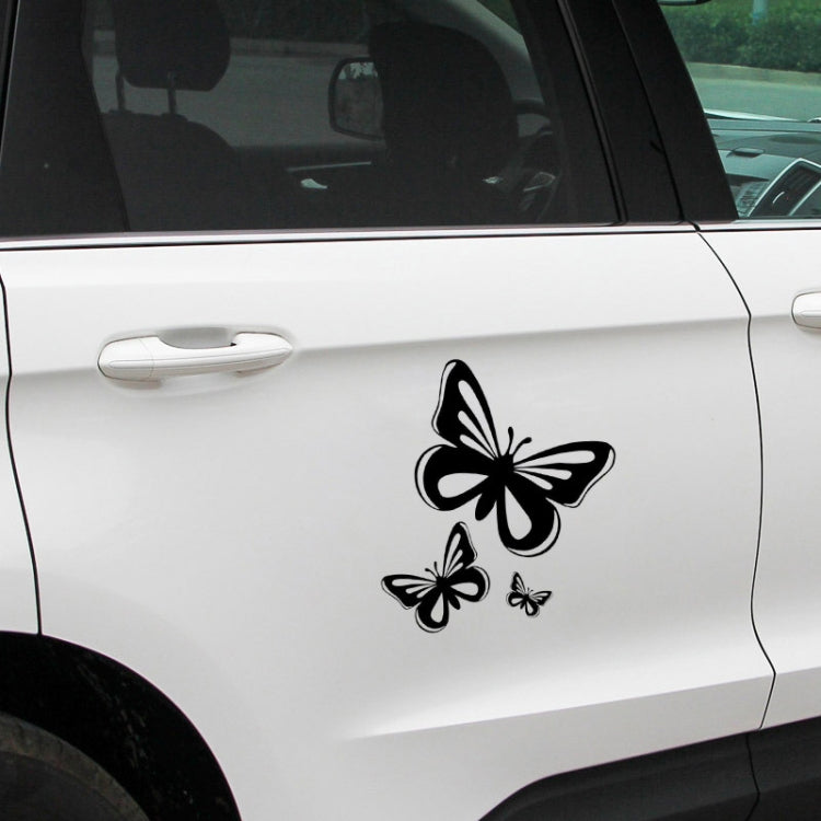 Black butterfly decal sticker set on a light car door surface