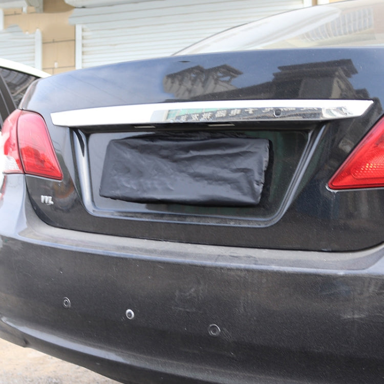 Black waterproof license plate cover installed on a car rear