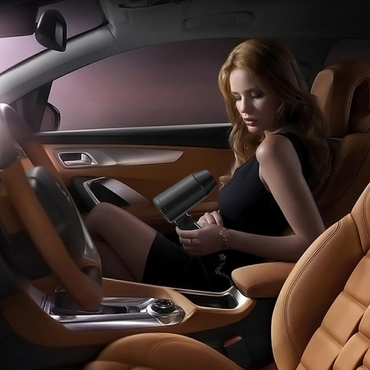 Handheld car hair dryer used inside a vehicle near the seat