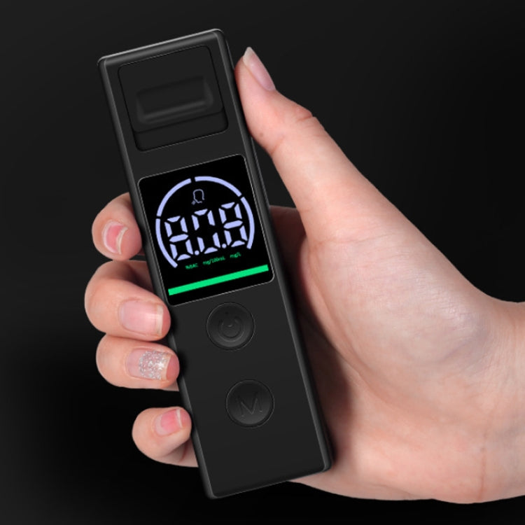 Breath alcohol tester held in hand, black body with lit LCD alcohol reading