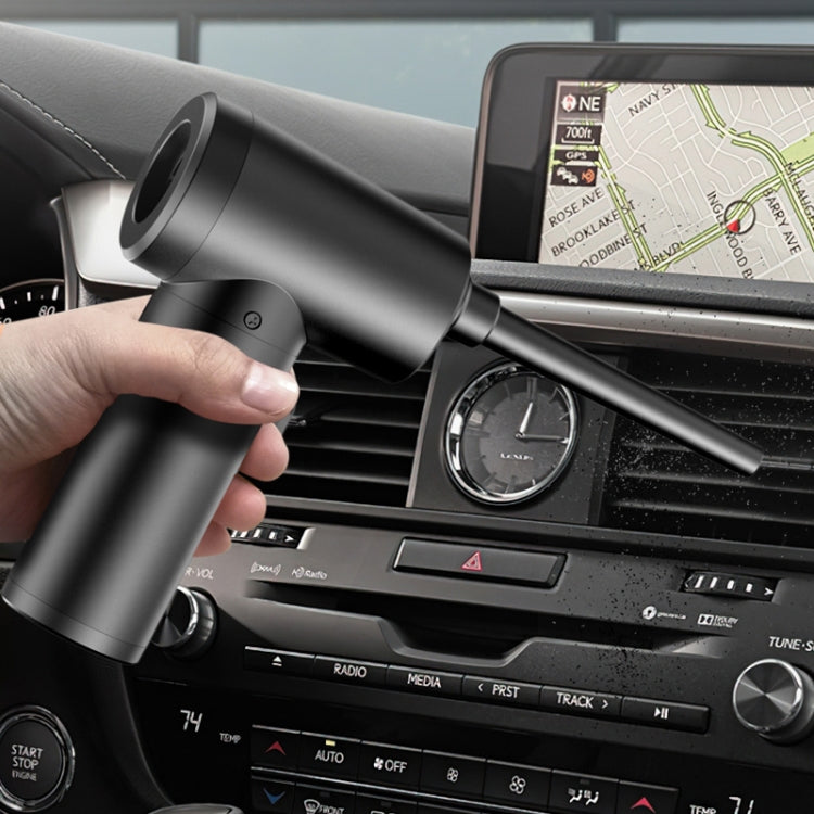 Wireless handheld vacuum air pump being used near car dashboard vents