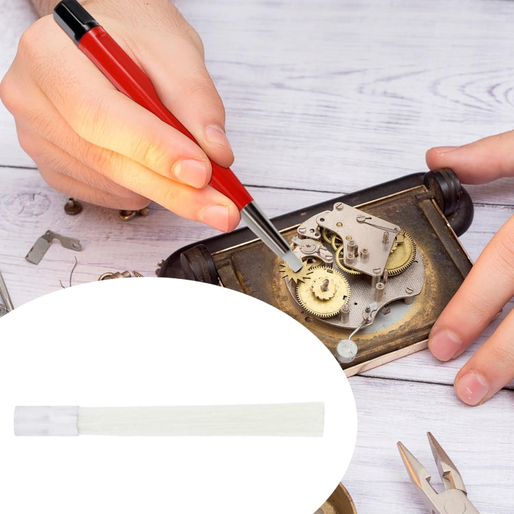 Replacement brush head cleaning a metal watch movement, white bristles