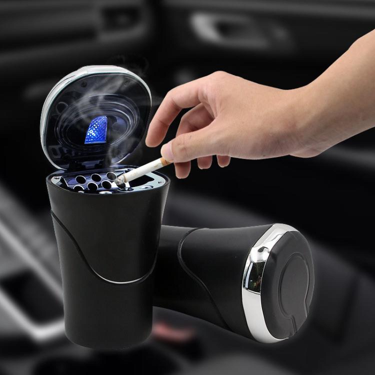Black car cigarette ashtray open with tray insert and lid placed beside it