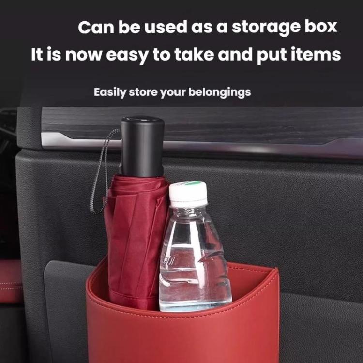 Red hanging leather car storage trash can holding a bottle and folded items
