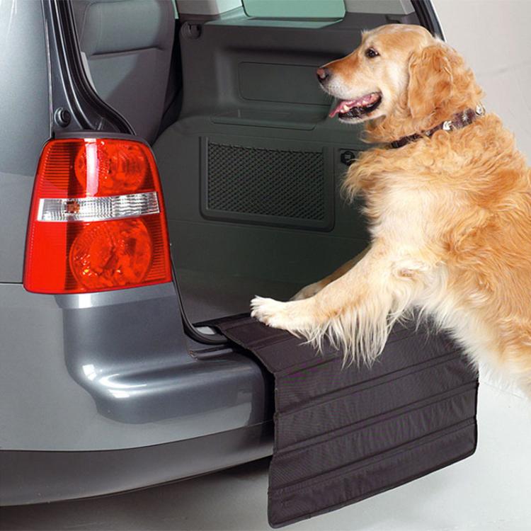 Foldable car trunk bumper protective mat installed in trunk area, with dog for scale