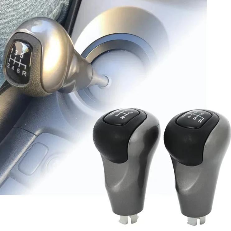 Manual gear shift knobs installed, black tops and silver bodies with gear labels
