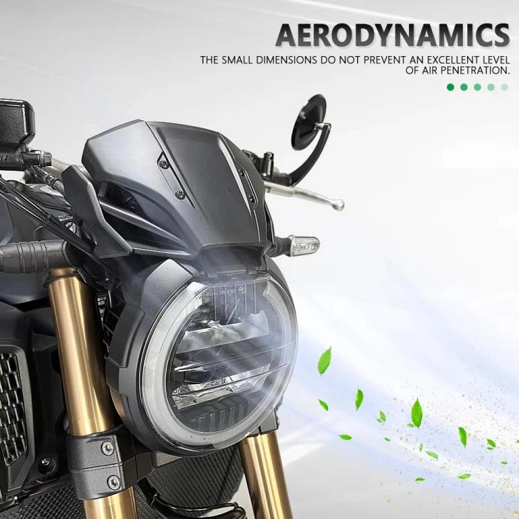 Black motorcycle windshield deflector mounted on the headlight area