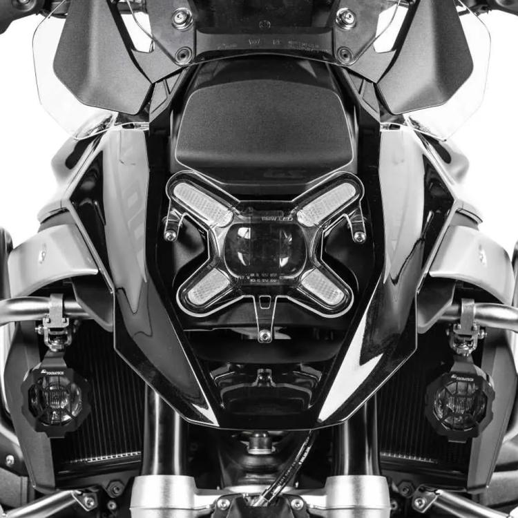 Clear headlight protector covering twin headlight lenses on motorcycle