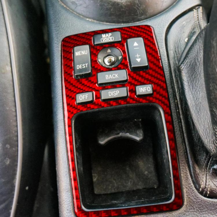 Center console panel sticker applied, red carbon fiber-style around buttons and display