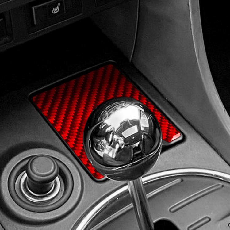 Red carbon-fiber ashtray panel sticker installed in car console