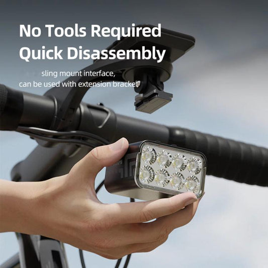 Bike light with sling mount interface, held in hand near handlebars