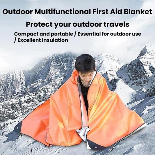 Orange emergency blanket tarp with dark corner tabs, draped like a shelter over a person