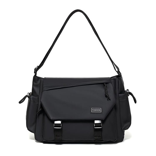 Black crossbody messenger bag with top handle, flap front, and adjustable shoulder strap