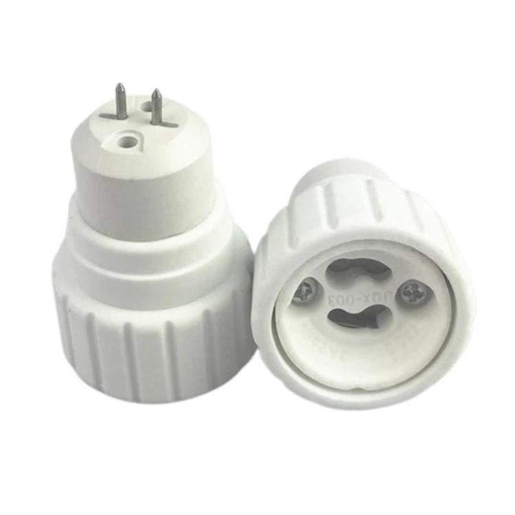 White PBT lamp base adapter showing underside with two pins and circular socket contacts