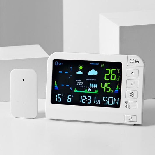 White wireless weather station on desk with color LCD and side control buttons