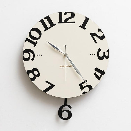Modern wall clock with cream face, black numerals, silver hands, and black hanging 6