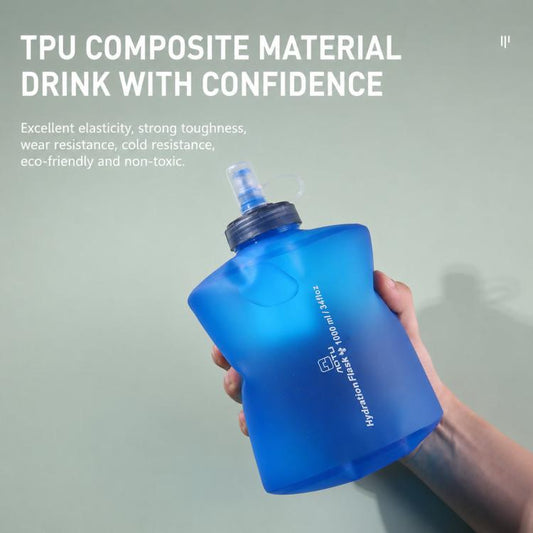 Collapsible blue TPU water bottle with screw cap, held in hand.