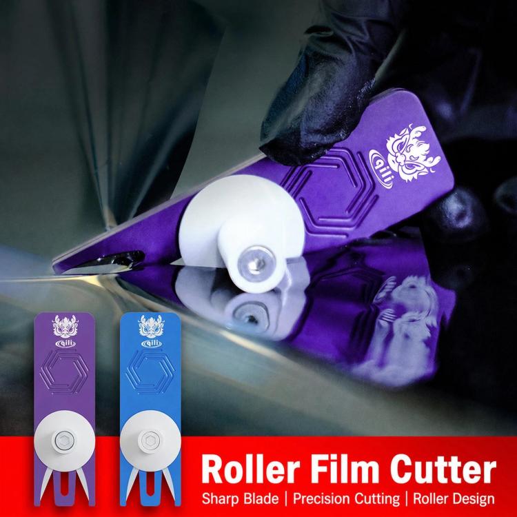 Purple roller film cutter with white wheel and blade, shown in use with glove