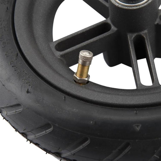 Close-up of rear wheel hub with valve and spokes on black tire
