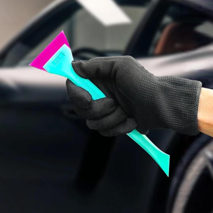 qili tint squeegee held in gloved hand, turquoise blade with pink tip