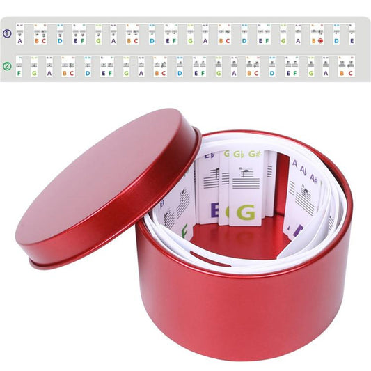 Removable piano key note labels in a red storage box with rolled 88-key strip inside