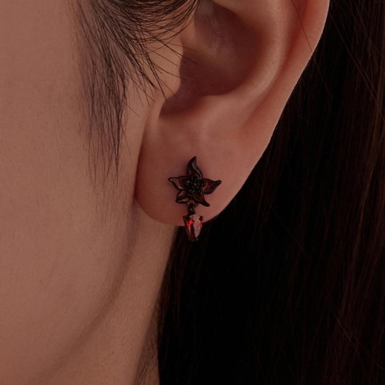 Gothic flower stud earring on ear, black petals with red enamel and amber teardrop dangle