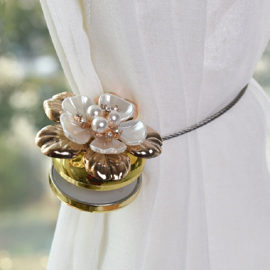Gold magnet curtain hook with ornate flower center and pearl bead accents