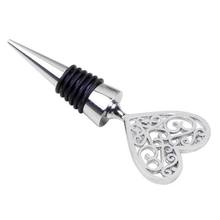 Metal wine stopper with ornate heart-shaped handle, black ribbed collar, silver finish.