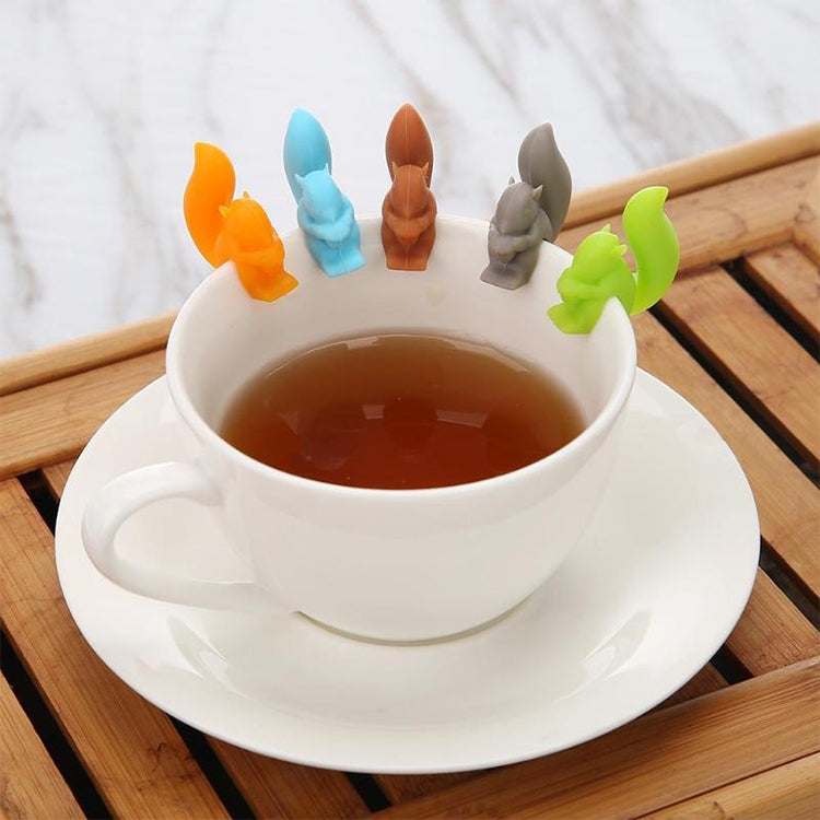 Silicone squirrel cup charms set, orange, blue, brown, gray, and green on teacup