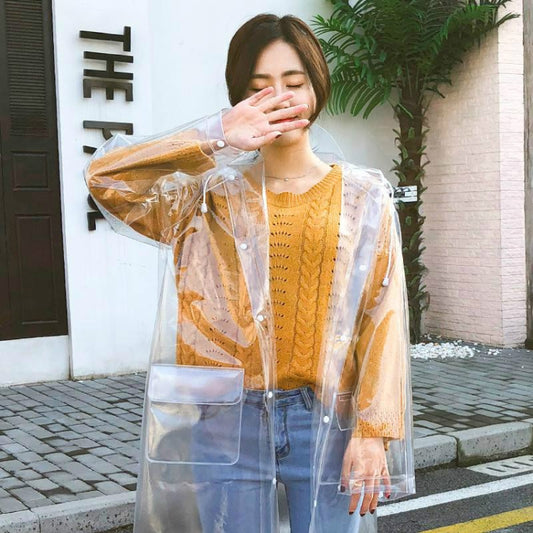 Transparent hooded raincoat with orange sleeves, button front and long coverage.