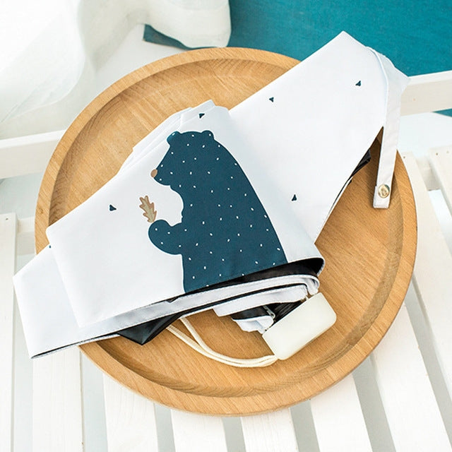 Mini folding umbrella, white fabric with navy bear print and compact snap-strap cover