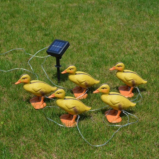 Duck-shaped solar garden lights: yellow ducks on orange stakes with small panel