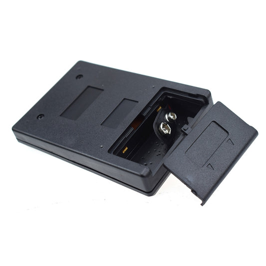 Black thermometer base with battery cover open and probe connector contacts