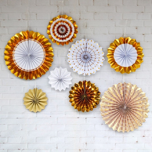Assorted gold and white paper fan flower decorations, round rosette cutouts