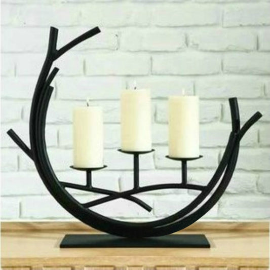 Black wrought iron horseshoe candle holder with three pillar candles on bases