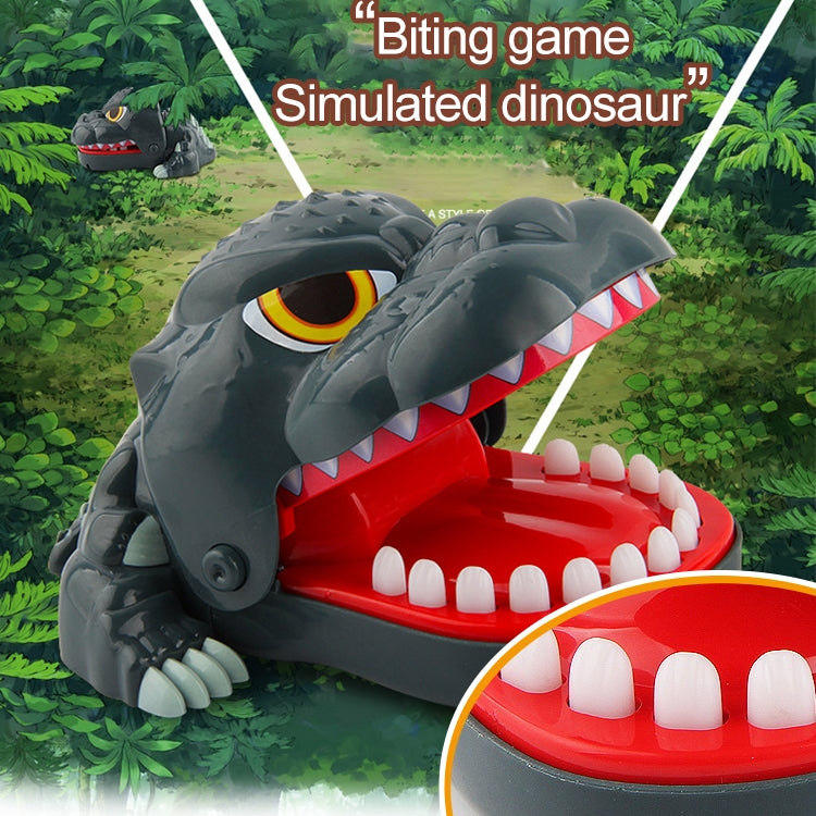 Gray dinosaur bite toy on green background with red mouth tray and white teeth
