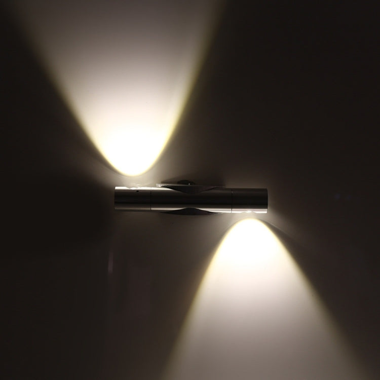 Rotating LED wall lamp emitting two light beams from dual heads