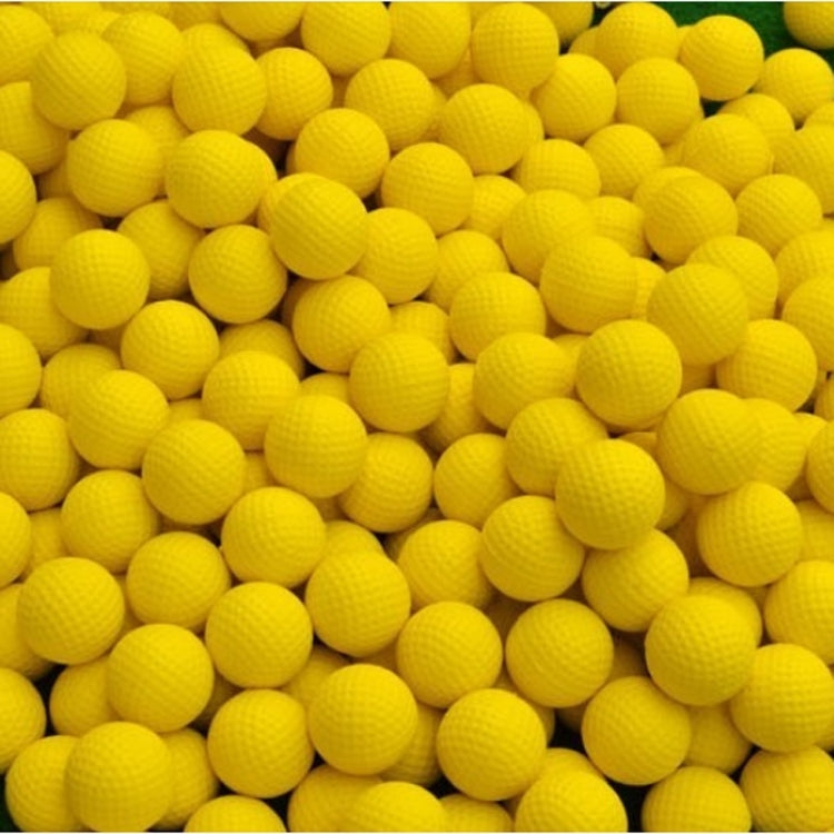 Yellow indoor golf rubber balls close-up showing dimpled texture