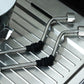 Pair of black ribbed silicone sleeves on coffee steam tubes over drip tray
