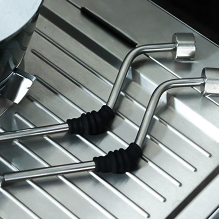 Pair of black ribbed silicone sleeves on coffee steam tubes over drip tray