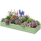 Light green galvanized raised garden bed filled with colorful blooming flowers