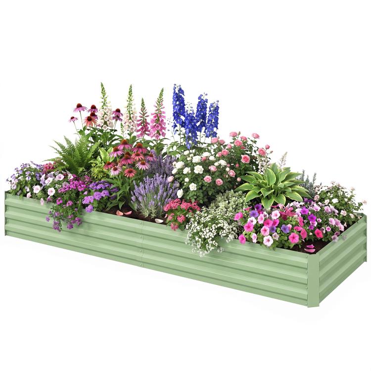 Light green galvanized raised garden bed filled with colorful blooming flowers