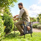 Gray garden seat with tool pouch on foldable steel frame while gardener trims plants.
