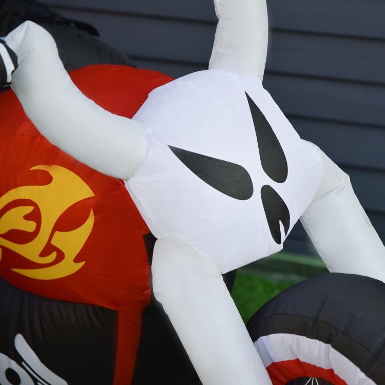 Inflatable white ghost biker yard decoration with black face, holding handlebars