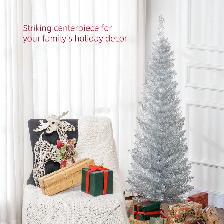 Silver unlit pencil artificial Christmas tree near wrapped presents and holiday decor