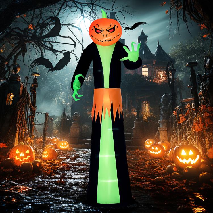 Inflatable pumpkin-head ghost figure with green hands, black body, and orange jagged hem